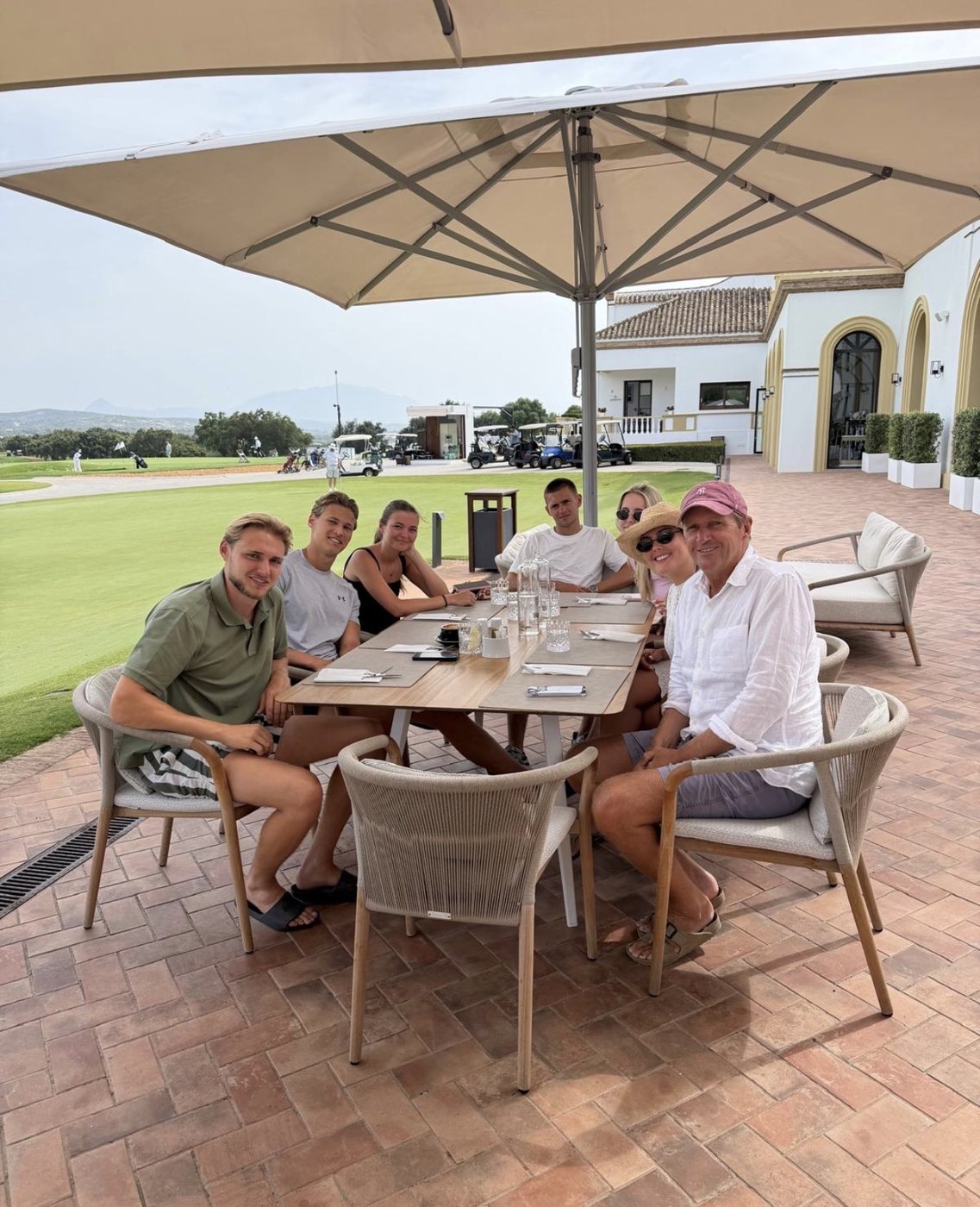 Darren with family and friends seated outdoors